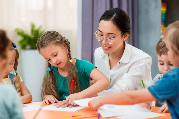 Teacher helping his students in class